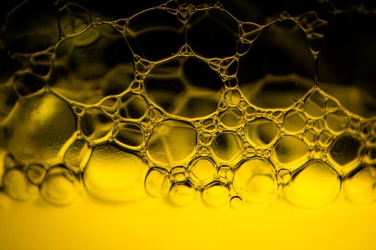 Vibrant abstract image showcasing soap bubbles in yellow light, perfect for backgrounds.